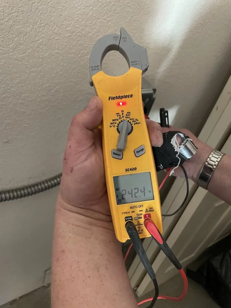 Voltage testing with clamp meter during Whole House Surge Protector in West Milton